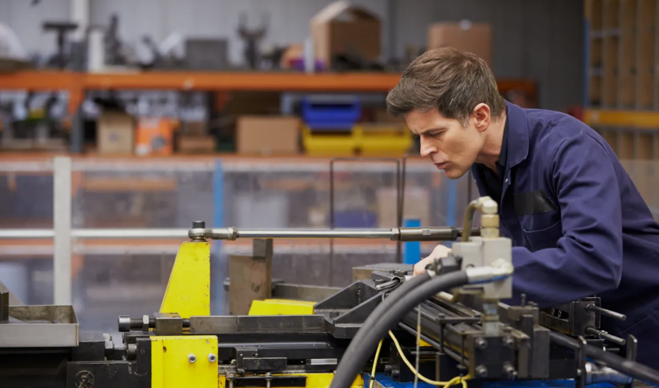 Manufacturing technician working with production equipment on a shop floor